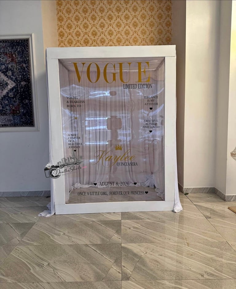 A framed Vogue limited edition magazine cover displayed on a wooden floor against a wallpapered wall in an interior space