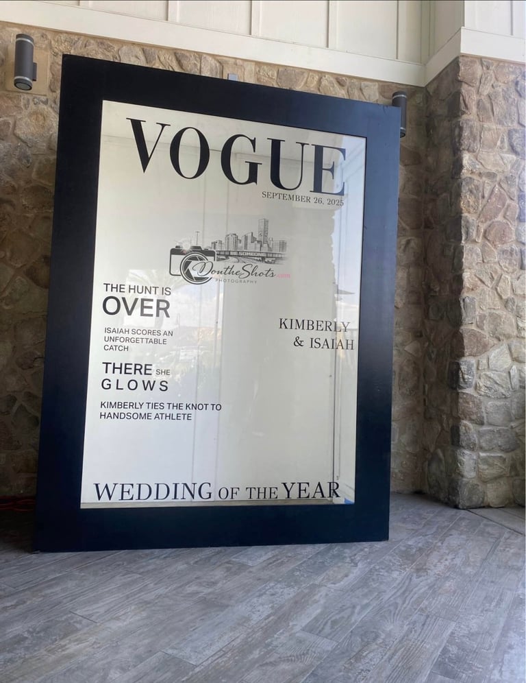 Large framed Vogue magazine cover displayed on stone wall featuring Wedding of the Year with names Kimberly and Isaiah