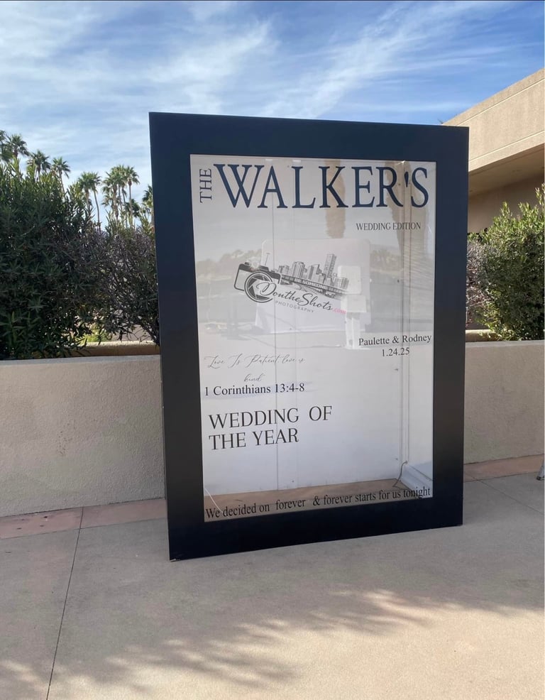 Large outdoor sign for The Walkers Wedding Edition featuring wedding details and a bride and groom illustration under blue sky